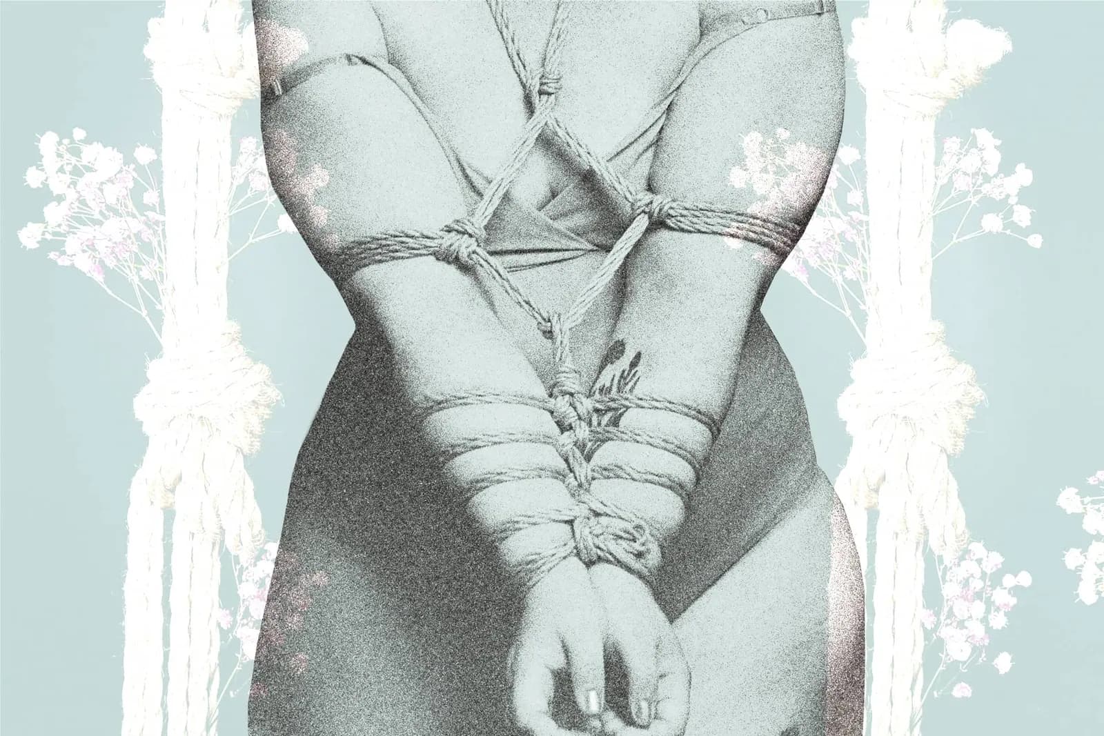 A person tied with an armbinder in the front, set against a soft pink background.