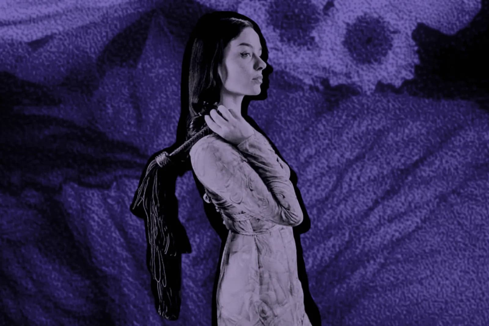 woman holding flogger against abstract purple background with ropes.
