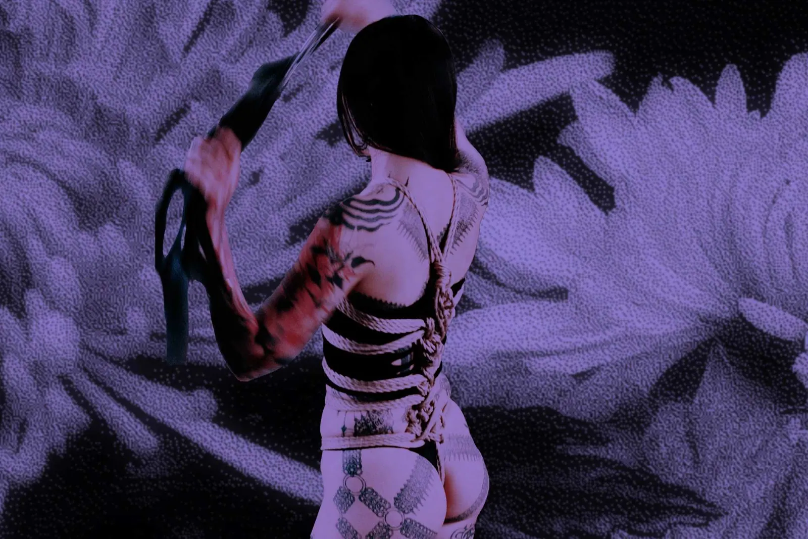 A tattooed figure tied in ropes wielding a flogger against a purple background with floral elements.