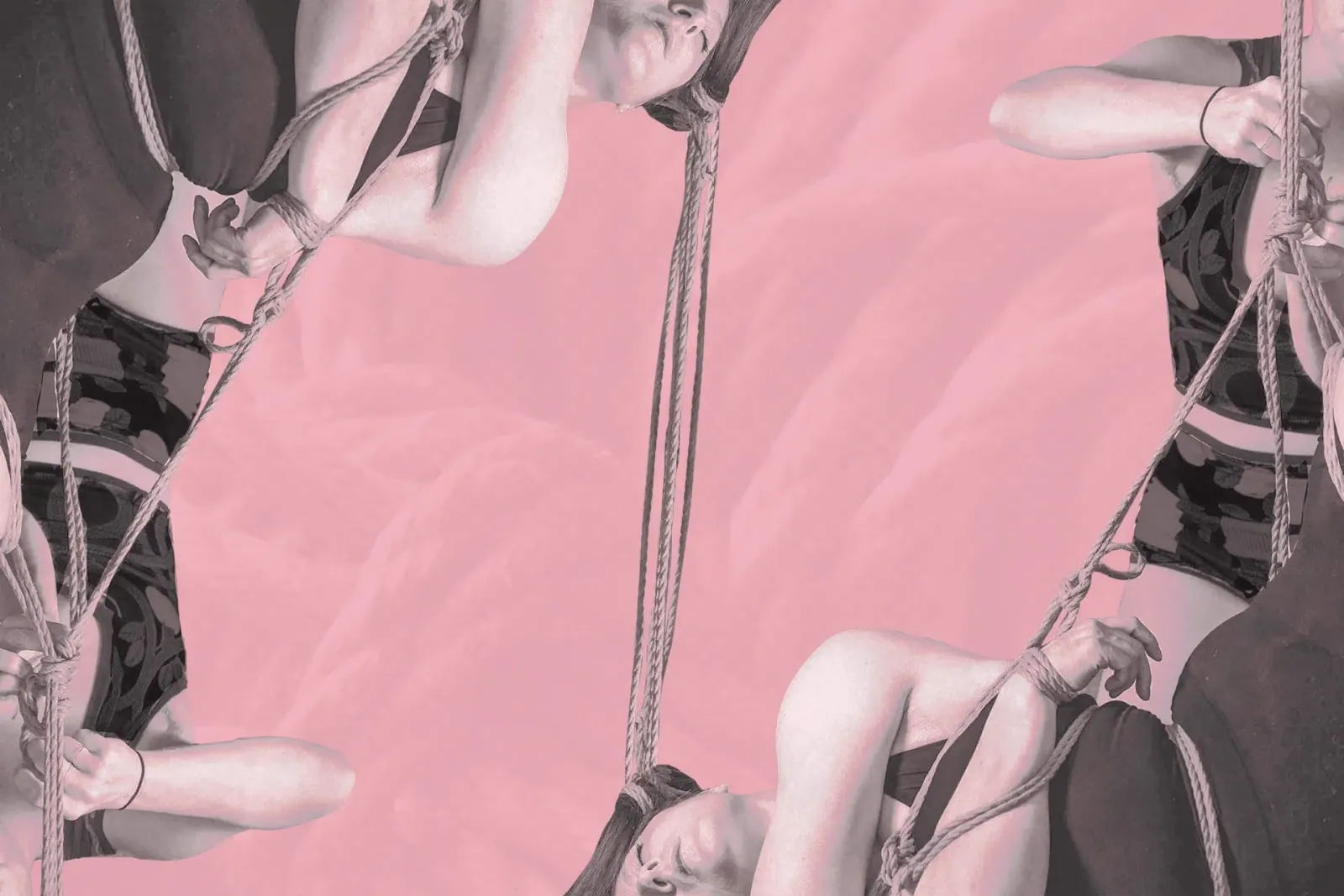 A rigger and bottom are tying a shibari suspension with hair rope on a pink background.