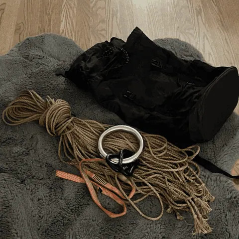 Rope bag contents including jute coils and bondage accessories.